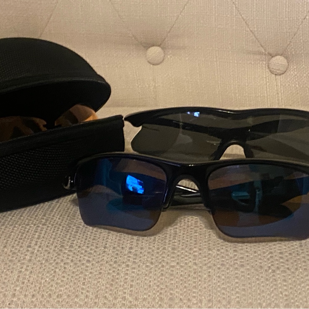 Two pair Oakley Black Sunglasses with one case